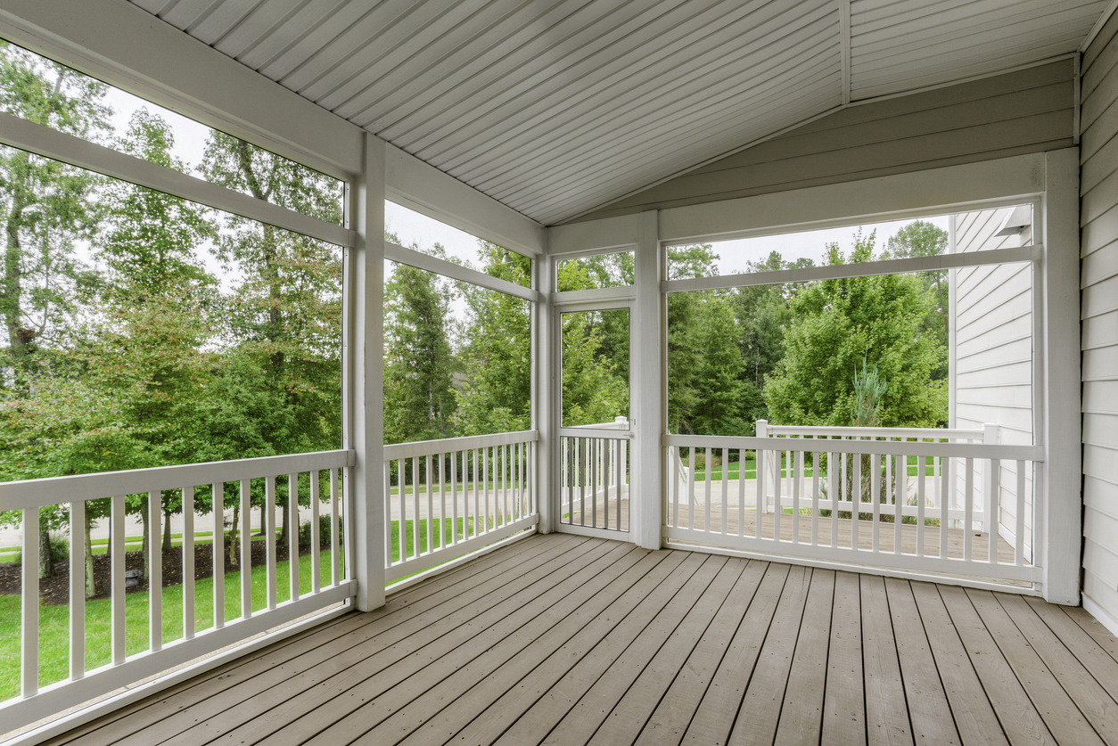 Covered screened porch with white railings